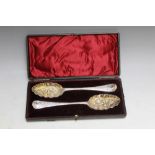 A CASED MATCHED PAIR OF HALLMARKED SILVER BERRY SPOONS, one being by William Withers - London
