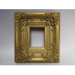 A 19TH CENTURY DECORATIVE GOLD PORTRAIT MINIATURE FRAME, with corner embellishments, width of