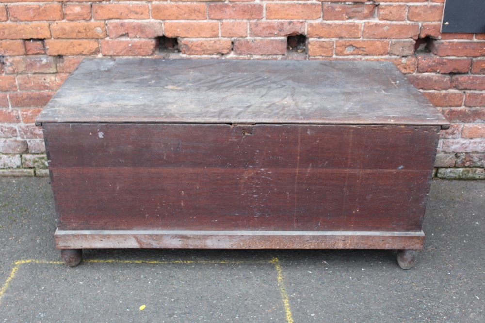 A LARGE ANTIQUE OAK HINGED BLANKET BOX, raised on bun feet, H 62 cm, W 140 cm, D 73 cm