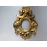 A LATE 18TH / EARLY 19TH CENTURY CARVED WOODEN GILT DECORATIVE MINIATURE FRAME, with oval
