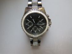 A MICHAEL KORS 'GUNMETAL' TONE WRISTWATCH, the face with a baguette crystal set border and further