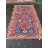 A LARGE EASTERN WOODEN RUG / KILIM, mainly on a red and blue ground, 336 x 179 cm
