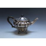 A HALLMARKED SILVER TEAPOT - SHEFFIELD 1846, of fluted type form and raised upon four foliate