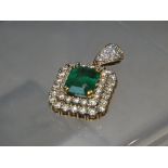 AN EMERALD AND DIAMOND ART DECO PENDANT, set with a central emerald cut emerald of an estimated 3.