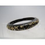 A LOUIS VUITTON BLACK AND GOLD INCLUSION BANGLE, clear / black resin with crystals and gold tone