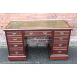 AN EDWARDIAN MAHOGANY TWIN PEDESTAL DESK, with inset tooled green leather writing surface, above