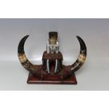 A 19TH CENTURY HORN / HOOF INKSTANDISH, having central glass square inkwell, raised on a mahogany