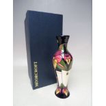 A MOORCROFT POTTERY 'TRILOGY' PATTERN SLENDER BUD VASE, designed by Rachel Bishop, impressed and