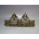 A VICTORIAN BRASS INKSTAND BY TOWNSHEND & CO, the base with extensive pierced detail supporting