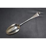A HALLMARKED SILVER SHELL BACKED SPOON - LONDON 1767, makers mark indistinct, approx weight 60g, L