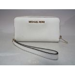 A LARGER MICHAEL KORS WINTER WHITE PURSE, complete with wrist strap, single zip closure, W 18 cm,