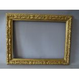 A 19TH CENTURY CARVED GILTWOOD DECORATIVE PICTURE FRAME, frame W 5 cm, rebate 43.5 x 32 cm