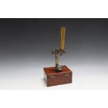 A SMALL MAHOGANY CASED BRASS FIELD MICROSCOPE, and contents, W 14 cm