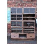 A LARGE VINTAGE OAK GLAZED HABERDASHERY STYLE CABINET, in three sections, the bottom section with