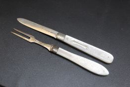 A MATCHED MOTHER OF PEARL HANDLED HALLMARKED SILVER FOLDING FRUIT KNIFE AND FORK SET, the fork dated