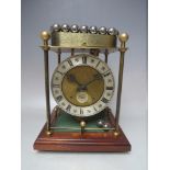 A THWAITES AND REED ROLLING BALL CLOCK, powered by a series of steel balls on a ferris wheel style