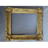 A 19TH CENTURY DECORATIVE GILT FRAME WITH LARGE CORNER EMBELLISHMENTS, framed W 12 cm, rebate 68 x