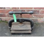 AN ANTIQUE CAST IRON BOOK PRESS, H 34 cm, W 44 cm, D 25 cm