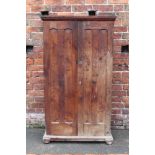A VINTAGE ELM TWO DOOR TALL SLIM CUPBOARD, the twin panelled doors with chamfered detail, raised