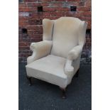A VINTAGE UPHOLSTERED WINGBACK ARMCHAIR, with horse hair, A/F