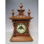 A GERMAN ARCHITECTURAL STYLE WOODEN CASED MANTEL CLOCK, with 8 day movement, striking on a single