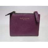 A SMALL KIRK GEIGER PLUM COLOURED SMALL LADIES WALLET, with double zip closure to top edge, press