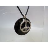 A THOMAS SABO STERLING SILVER PEACE SYMBOL PENDANT / CHARM, H 3 cm together with a larger Thomas