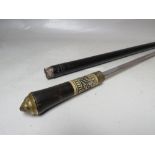 A VINTAGE EBONISED GENTS WALKING CANE / SWORD STICK, with brass lions head pommel and carved bone