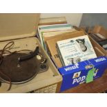 A VINTAGE DECCALIAN MODEL T CASED RECORD PLAYER A/F, together with a selection of vintage records,
