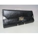 A VINTAGE LEATHER TRAVEL WALLET FOR GLOVES AND HANDKERCHIEFS, black textured leather exterior with
