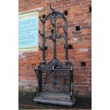 A DECORATIVE CAST IRON HALL STAND, the arched top above nine hooks, with a twin stick stand below