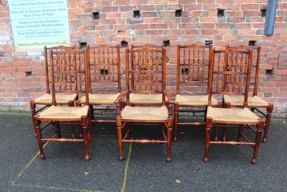 A SET OF EIGHT OAK AND WICKER SEAT CHAIRS, with typical spindle backs (7 + 1)