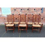 A SET OF EIGHT OAK AND WICKER SEAT CHAIRS, with typical spindle backs (7 + 1)