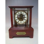 AN EARLY TWENTIETH CENTURY EUREKA BATTERY OPERATED MANTEL CLOCK, under a five glass mahogany case,