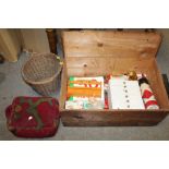 AN ANTIQUE PINE LIDDED STORAGE BOX AND CONTENTS, to include an upholstered kneeling stool, wicker