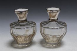 A PAIR OF 1920'S CONTINENTAL SILVER AND IVORY TOPPED SCENT BOTTLES, stamped 800, one has loose