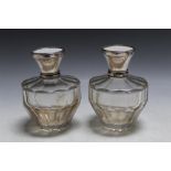 A PAIR OF 1920'S CONTINENTAL SILVER AND IVORY TOPPED SCENT BOTTLES, stamped 800, one has loose