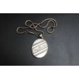 AN ANTIQUE LOCKET, in unmarked white metal on snake link style chain, H 6 cm inc bail