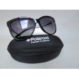 A PAIR OF POLAROID POLARIZED SUNGLASSES, cased with cleaning cloth
