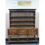 A NINETEENTH CENTURY OAK DRESSER, the enclosed plate rack above a lower section with five drawers