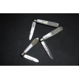 A COLLECTION OF THREE HALLMARKED SILVER BLADED MOTHER OF PEARL FRUIT KNIVES, various dates and