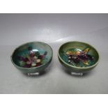 TWO SMALL MOORCROFT POTTERY FOOTED BOWLS WITH TYPICAL TUBE LINED DECORATION, one in the Aquilegia