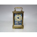 A FINE MINIATURE FRENCH CARRIAGE CLOCK, having a brass case, blue floral enamelled dial and
