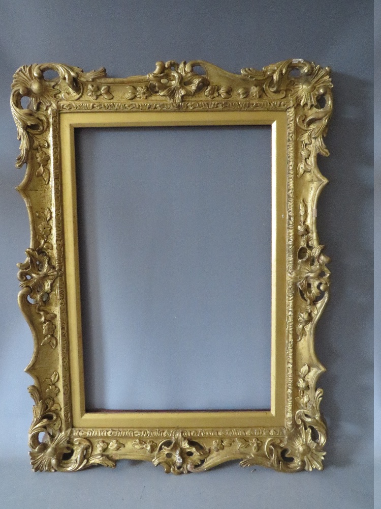 A 19TH CENTURY CARVED WOODEN GILT SWEPT AND PIERCED FRAME, with integral slip, frame W 7.5 cm,