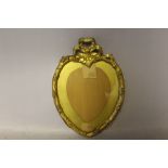 A NINETEENTH CENTURY SMALL HEART SHAPED GOLD FRAME, with adornment to top edge, width of frame 1.5