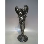 AN ART NOUVEAU METALWARE VASE WITH FEMALE FIGURAL EMBELLISHMENT, the embossed decoration depicting a