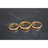 THREE HALLMARKED 22 CARAT GOLD WEDDING BANDS, approx combined weight 14.2g
