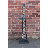 A GRAND TOUR DESIGN BLACK PIETRA DURA OBELISK, inlaid with various specimens and decorative hard