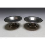 TWO TUDRIC PEWTER SHORT COMPORTS, having typical hammered finish, tallest 6 cm