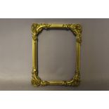 A NINETEENTH CENTURY SMALL DECORATIVE GOLD FRAME, with corner embellishments, width of frame 1.5 cm,